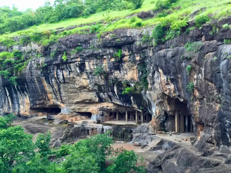 Pitalkhora caves cut into a cliff above a green gorge